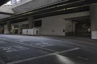 a empty street with parking lots at night, and empty space between two walkways