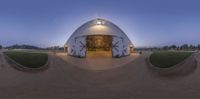 this 360 - lens shot is of the exterior of a building that appears to be being built in the middle of the town