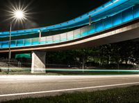 a very long exposure photo shows an underpass and lights from the night time to day