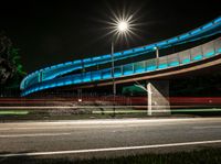 a very long exposure photo shows an underpass and lights from the night time to day