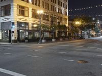 empty streets at night near tall building in the city of san francisco, california usa