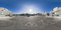 an upside down view of a modern building and parking lot, showing the circular opening of the garage