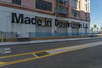 an empty street near a store that has some signs on it in front of a building