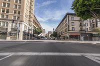 an empty city street with many cars driving on it, in a blurry photo