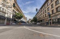 an empty city street with many cars driving on it, in a blurry photo