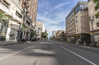 an empty city street with many cars driving on it, in a blurry photo