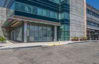 a building in an empty lot in a city area, with a clear sky behind it