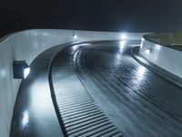 the illuminated tracks in this snowy and mountainous race track are extremely high - tech for downhill skiing