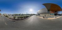 a photo taken from a fish eye lens of a street corner in a residential neighborhood