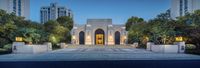 the entrance to the building that houses the national theater of california city, at dusk