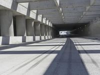 a tunnel that looks like it has some cars on it and is in between the buildings