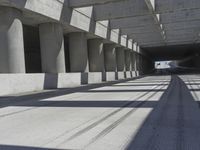 a tunnel that looks like it has some cars on it and is in between the buildings