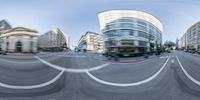 a wide shot of a city street is shown in this image taken with a fish eye lens