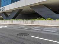 a city street with an awning in the corner near the curb on the road