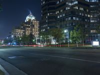 a night scene of the city lights on a street corner with an empty parking lot