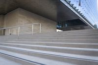 there are stairs that have rails and railings attached to them while people walk down one set