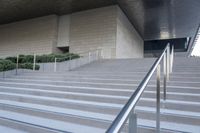 there are stairs that have rails and railings attached to them while people walk down one set