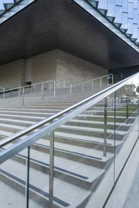 there are stairs that have rails and railings attached to them while people walk down one set