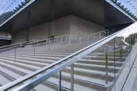 there are stairs that have rails and railings attached to them while people walk down one set