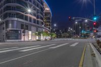 a cross walk with a building in the background on a cloudy day at night time