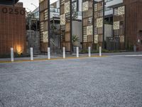 a row of concrete poles in front of a building that reads 2020 with lights on the bottom
