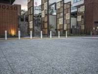 a row of concrete poles in front of a building that reads 2020 with lights on the bottom