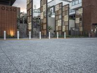 a row of concrete poles in front of a building that reads 2020 with lights on the bottom