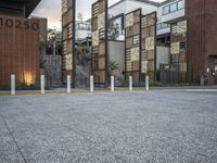 a row of concrete poles in front of a building that reads 2020 with lights on the bottom