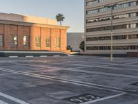 an empty parking lot in front of a building with palm trees on it and numbers and numbers on it