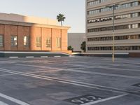 an empty parking lot in front of a building with palm trees on it and numbers and numbers on it