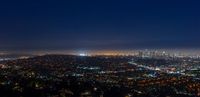 the los angeles skyline at night as seen from the griffith heights overlook photo via flick