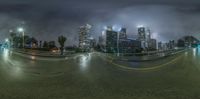 a street and street view with skyscrapers in the background at night time and bright light on buildings