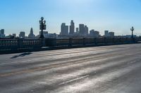 a view of a city with a bridge going over it and a man walking down the sidewalk