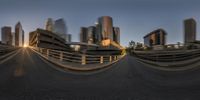 the view of a city from the top of a bridge in motion with a blurry effect