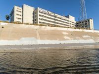 the brown water is flowing along the street as it flows down the shoreline near the city