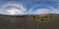 this is a 360 - degree view of the paved road and the sunset on the horizon