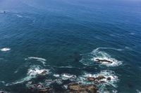 several people are parasailing over the ocean with one person on the airboard