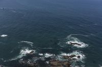 several people are parasailing over the ocean with one person on the airboard