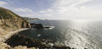 a view of the ocean from high on top of a cliff looking toward the ocean