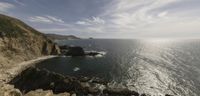 a view of the ocean from high on top of a cliff looking toward the ocean