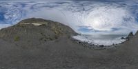 fish eye view from the bottom of some rocks and a surfboard in the water