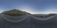 fish eye lens of a winding road, on an island by the ocean at sunset