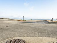 the pavement is empty in front of a stop sign and beach side neighborhood sign on a sunny day