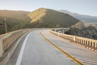 a view of a curvy road by the ocean in california state usa at sunset
