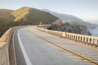 a view of a curvy road by the ocean in california state usa at sunset
