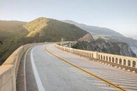 a view of a curvy road by the ocean in california state usa at sunset