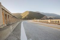 a view of a curvy road by the ocean in california state usa at sunset