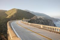 a view of a curvy road by the ocean in california state usa at sunset