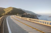 a view of a curvy road by the ocean in california state usa at sunset