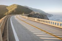 a view of a curvy road by the ocean in california state usa at sunset